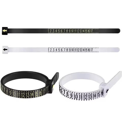 Three plastic measuring tape-style zip tie bands shown on a white background: one black with a black arrow, one white with a black arrow, and one black loop with a white handle. Each band has printed size numbers 1 through 17.