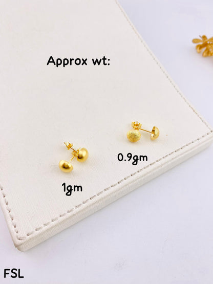 Gold earrings on a white card with weight labels