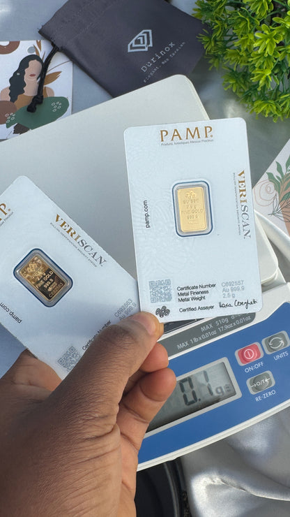 Gold bars on display with 'PAMP' and 'Vera Silver' branding, held by a hand over a digital scale.