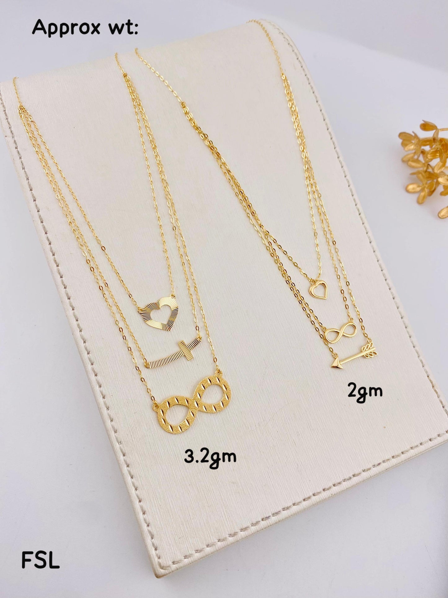 Gold necklaces with various designs on a white card, showing weight measurements.