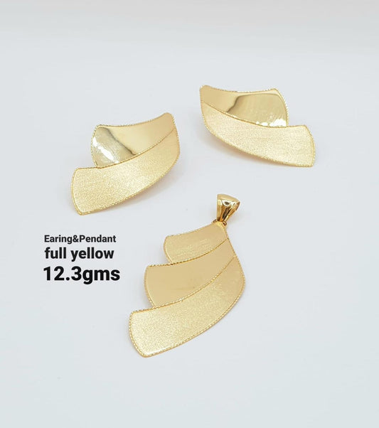 Gold earring and pendant set on a light gray background