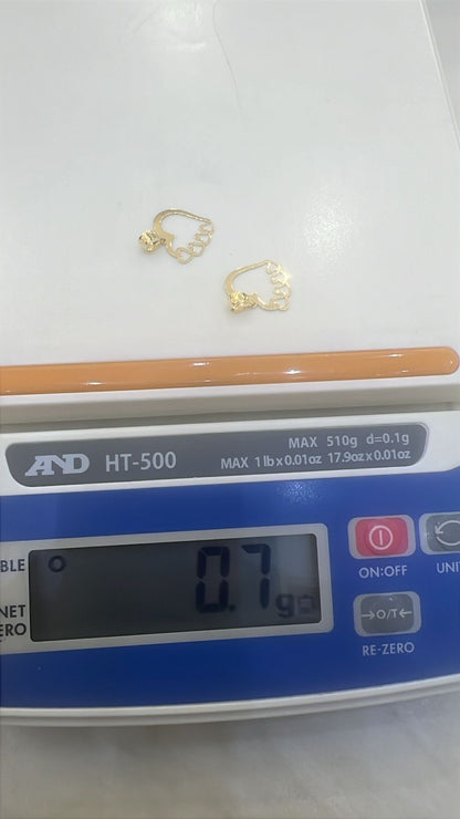 Gold pendants (Love/Heart design) on a digital scale displaying weight
