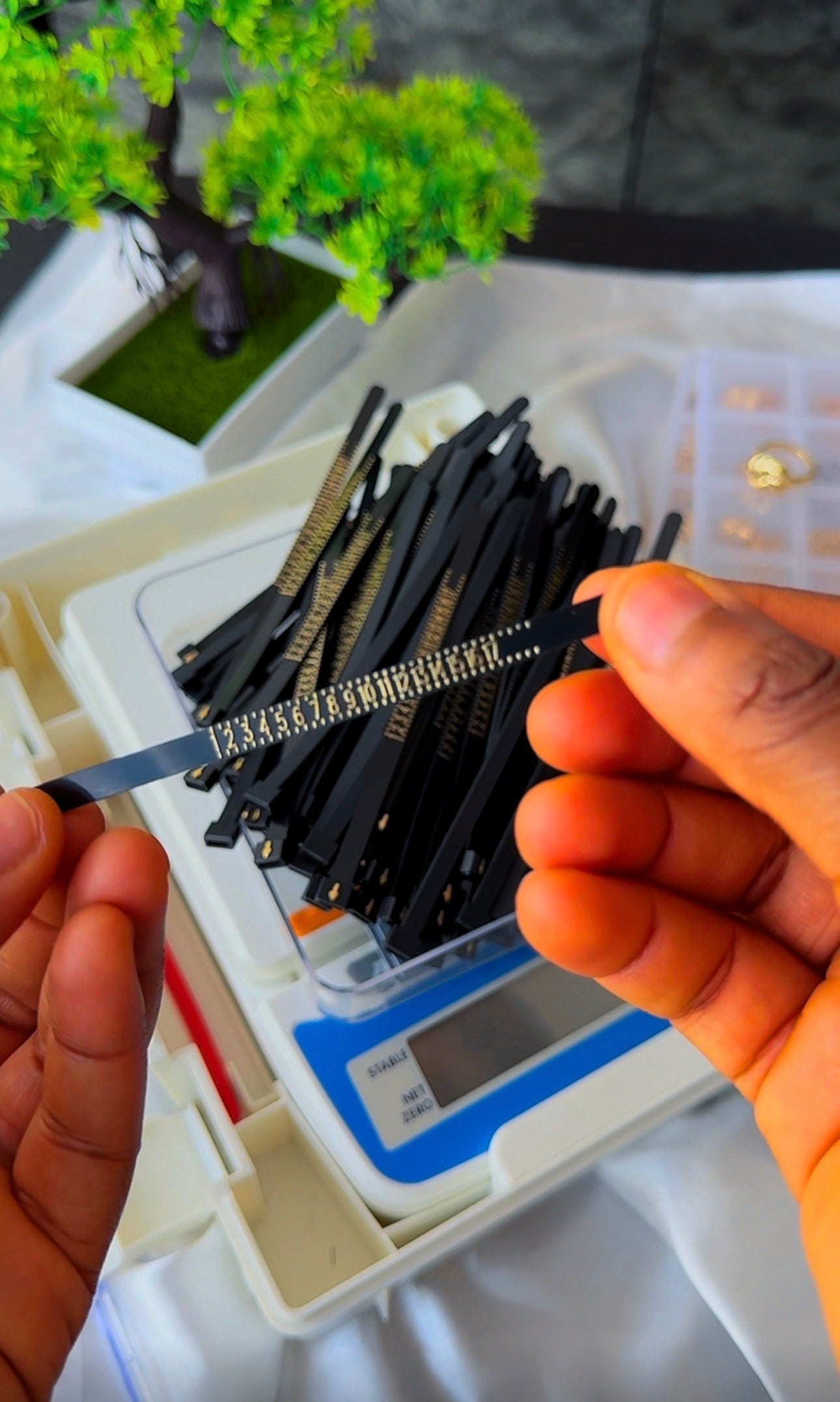 Adjustable plastic ring sizer looped into ring shape for measuring finger size