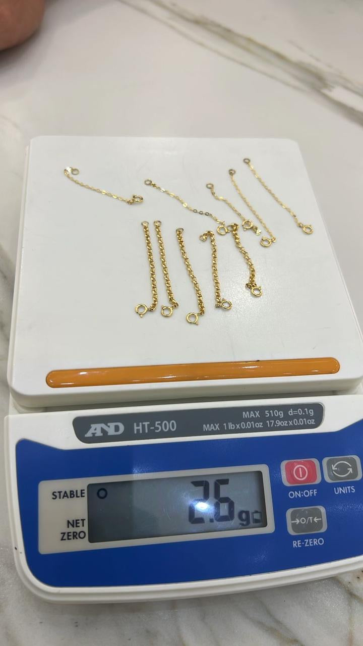 Gold necklaces on a digital scale displaying weight